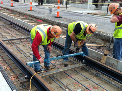 Workers align track to specification